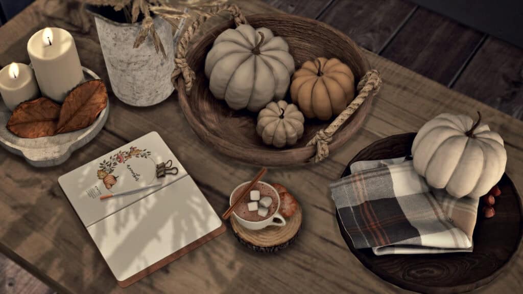 Pumpkin fall decorations with candles, dried leaves, and cozy fall-themed items on wooden table for autumn harvest or Thanksgiving decor.