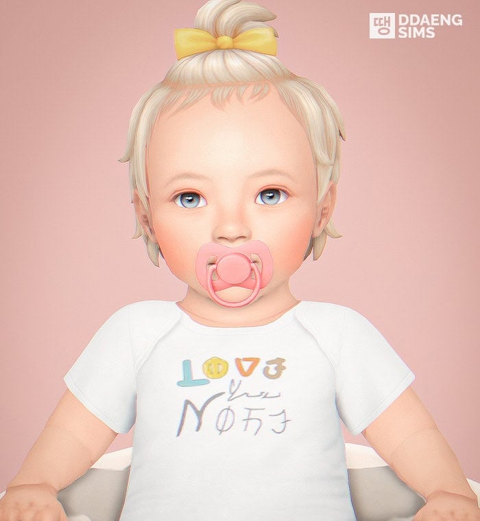 Baby doll with blonde hair, pacifier, yellow bow, and white shirt with "LOVE" text, realistic child figure, must-have mods for doll customization, adorable baby toy, baby doll for home decor and collection.