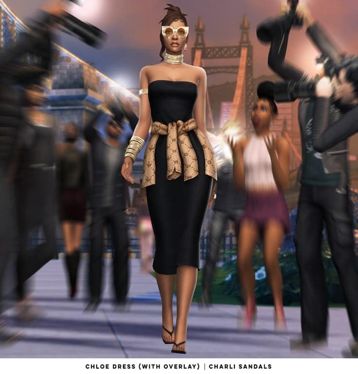 Chloe dress with overlay and Charli sandals on a virtual runway featuring a cityscape background. Perfect for fashion enthusiasts seeking stylish mod-inspired outfits and accessories.