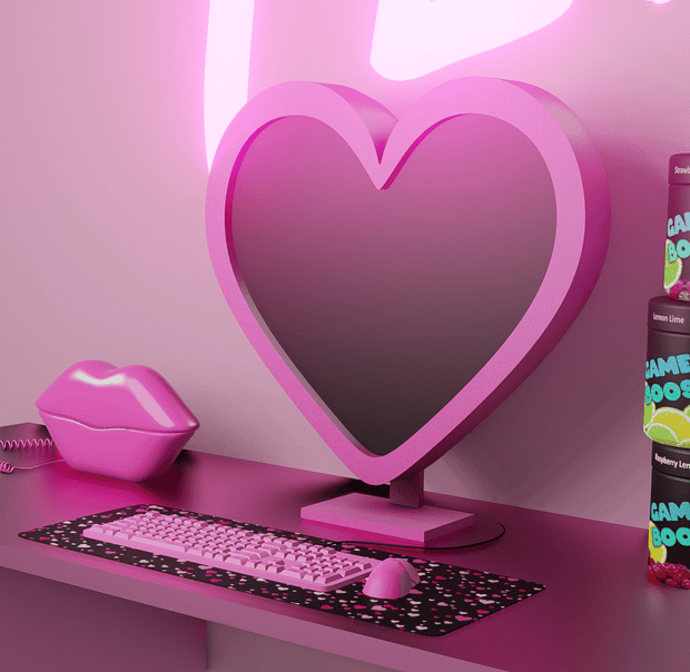 Heart-shaped mirror with pink frame, gaming accessories, and colorful gaming snacks on a pink desk representing a trendy gaming setup with vibrant aesthetics.