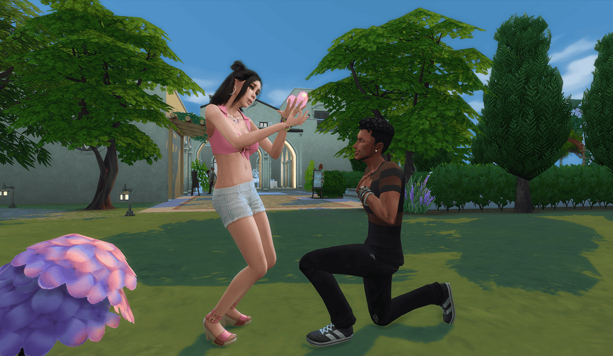 Romantic proposal scene from The Sims 4, featuring a male Sim kneeling with a ring in front of female Sim holding a heart-shaped object, set in a lush garden with trees and vibrant foliage.